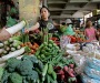A shopper buys a vegetable in a market in Hanoi, Vietnam, Tuesday, May 27, 2008.  Rising food and construction costs drove Vietnam's inflation rate to 25 percent in May, the highest rate in more than a decade. (AP Photo/Chitose Suzuki)